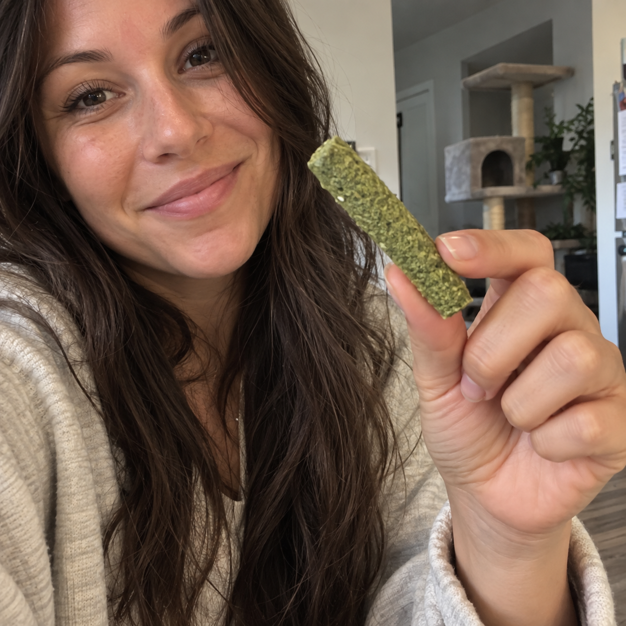 files/Smiling_Woman_Showcases_Green_Pet_Treat.png